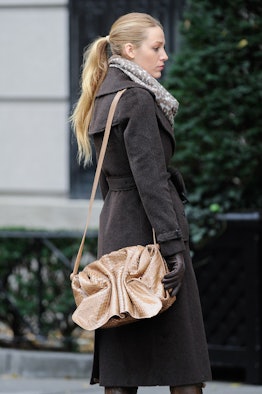 Blake Lively in a ponytail wearing a black wool trench coat