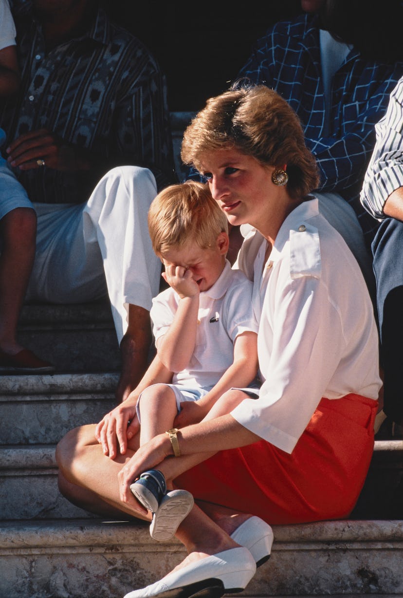 Princess Diana holds Harry while he cries