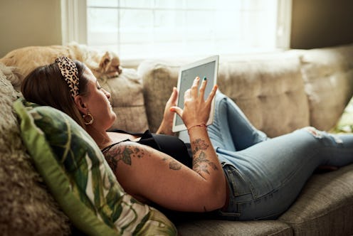 A woman lies on her couch while practicing social distancing during the coronavirus outbreak