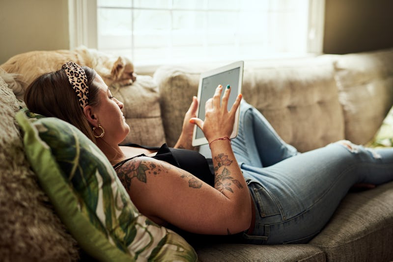 A woman lies on her couch while practicing social distancing during the coronavirus outbreak