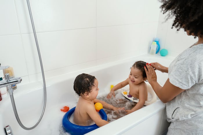 mom giving twin babies a bath
