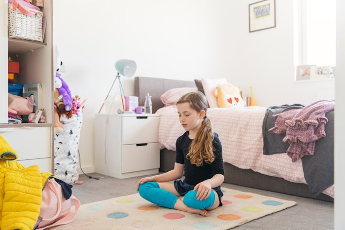 girl meditating in bedroom