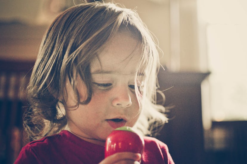 toddler singing into a toy microphone