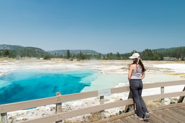 A young woman looks over the basins in Yellowstone National Park.