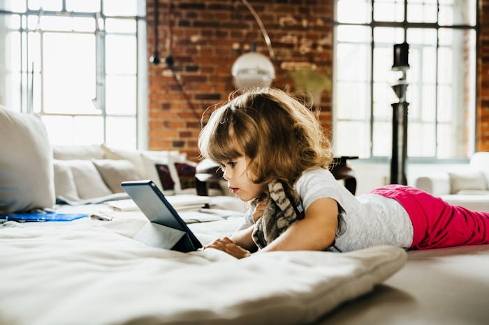 little kid watching tablet