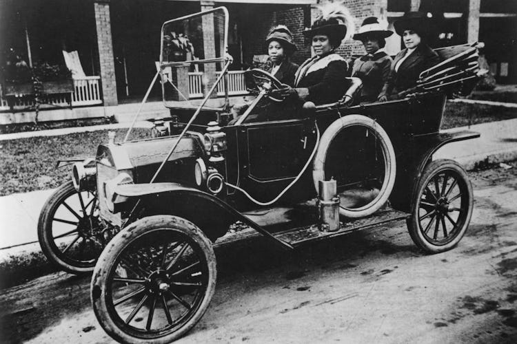 A photograph of Sarah Breedlove, better known as Madam C.J. Walker, driving a car.
