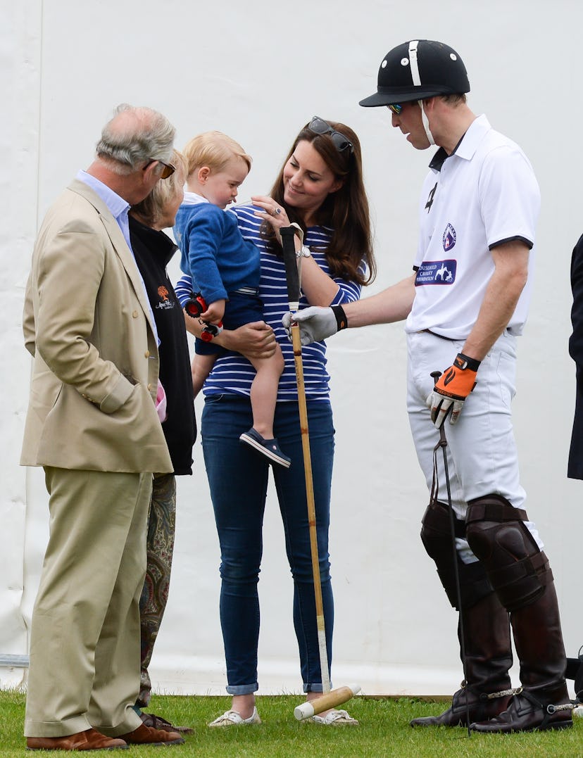 Prince William looks to be talking polo with Prince George as his dad Prince Charles looks on.