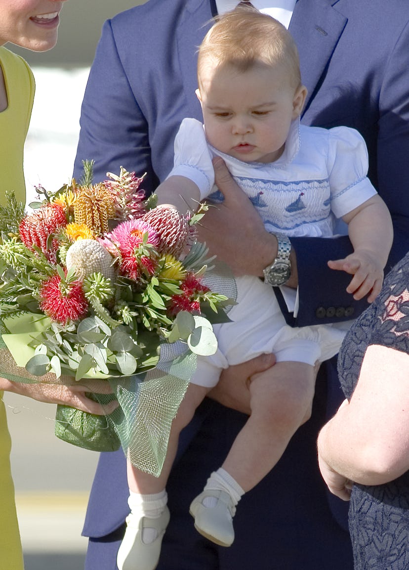 Prince George reaches for his mom's flowers.
