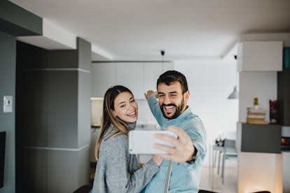 A young couple shows off their apartment while on video chat with their friends.