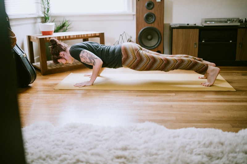A woman does pushups in her bedroom. The viral "see 10 do 10" instagram challenge is just another wa...
