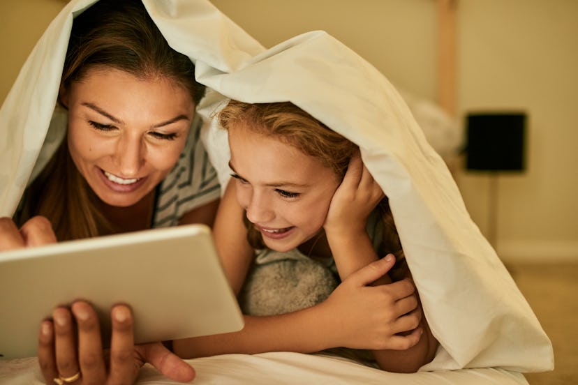 happy kid looking at tablet having a virtual playdate