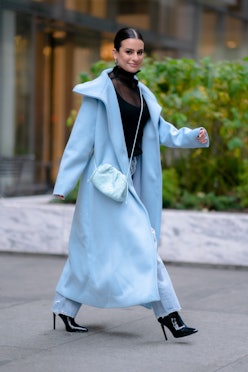 Lea Michele in a baby blue coat and matching pants with a sheer black turtleneck and black heels