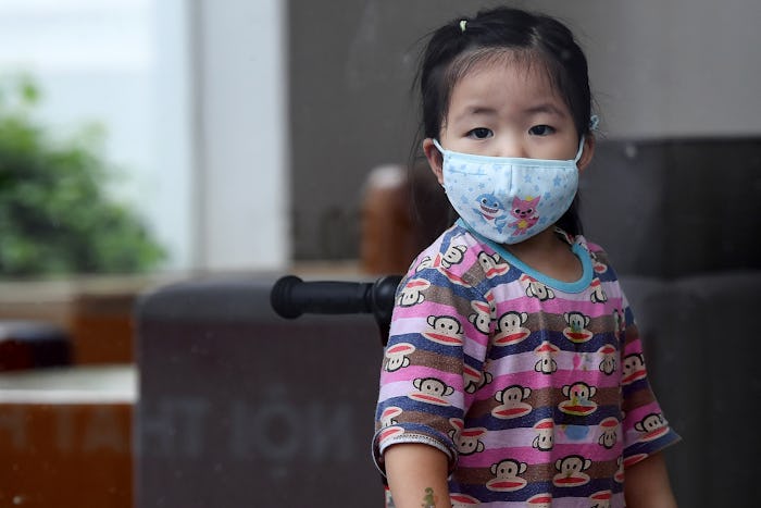 a little girl with a face mask to protect against coronavirus