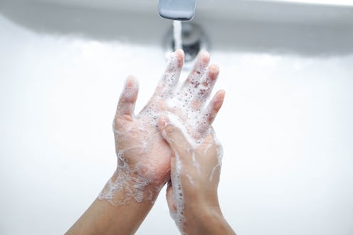 A person washes their hands. Experts explain how to manage anxiety around COVID.