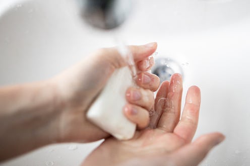 A woman washes her hands as hygiene practice during the spread of the coronavirus. Myths about the c...