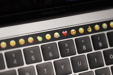 A photo of a keyboard with emojis above it