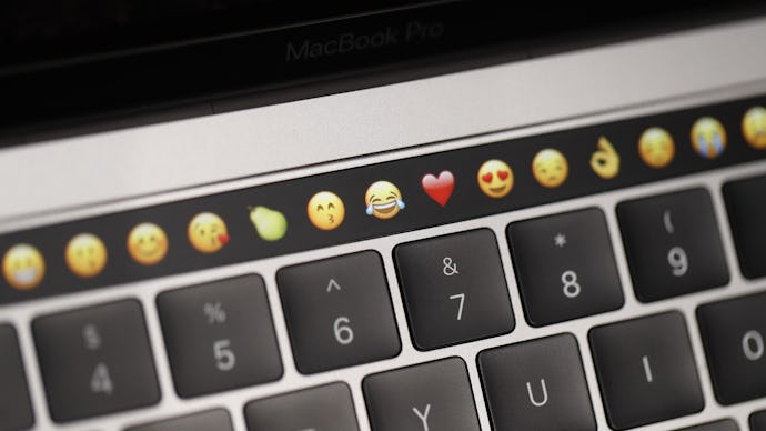 A photo of a keyboard with emojis above it