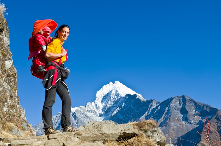 A mom hiked in Mount Everest with her child on her back.