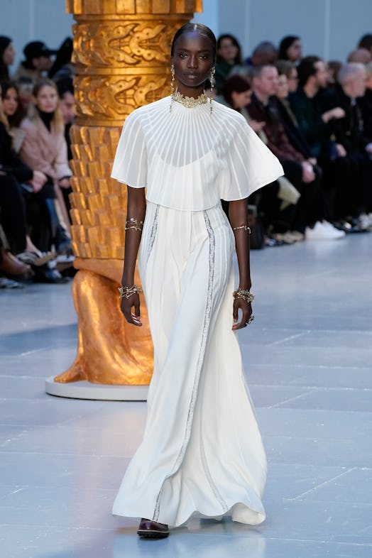 A model wearing a white pleated maxi dress by Chloe
