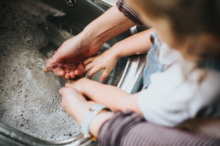 mom and little girl washing hands