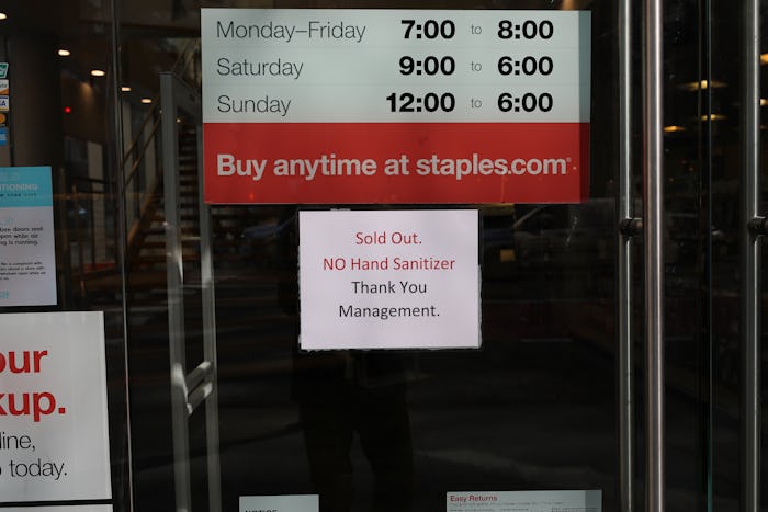 a sign in a "staples" window telling customers the store is sold out of hand sanitizer