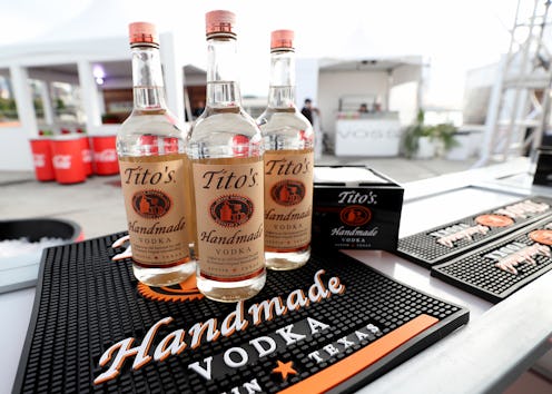 Three bottles of Tito's Vodka stand on an outdoor bar. Tito's Vodka has issued a statement to its co...