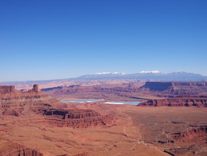 Canyonlands National Park is filled with red rock and distant mountain views.