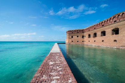 Dry Tortugas National Park in Florida features teal waters, coral reefs, and a brick walkway.