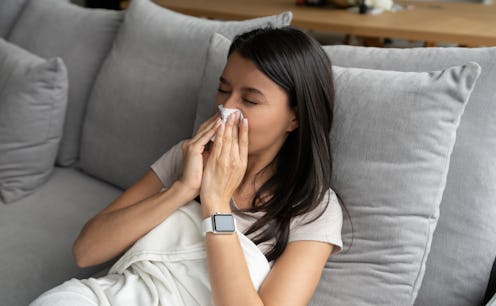 A person in a white shirt lays in bed and blows her nose. Spring allergies can definitely feel much ...