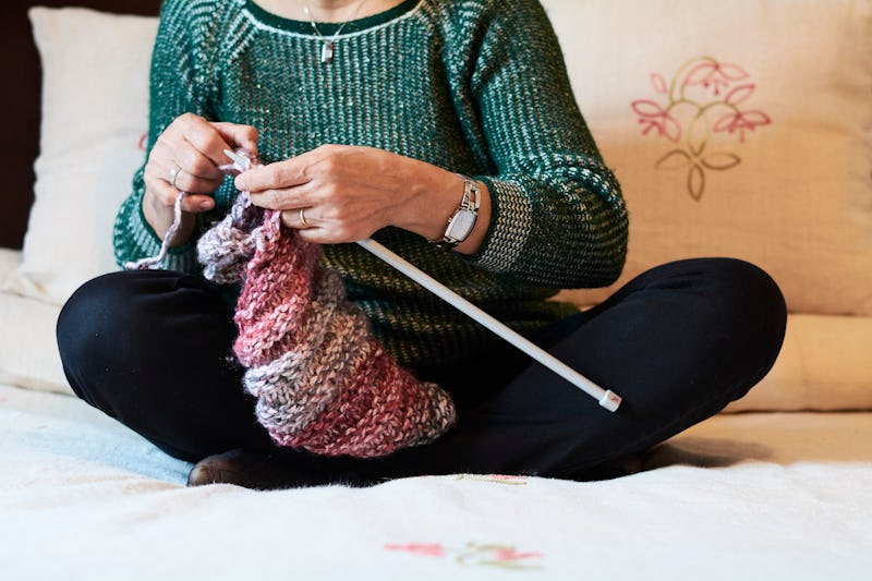 A woman knits a sweater. Any creative art practice can help your mental health, experts say