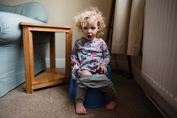 little girl sitting on potty chair