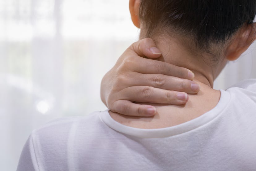 A person tries to rub out some pain in their neck. Your upper body and hips can get especially sore ...