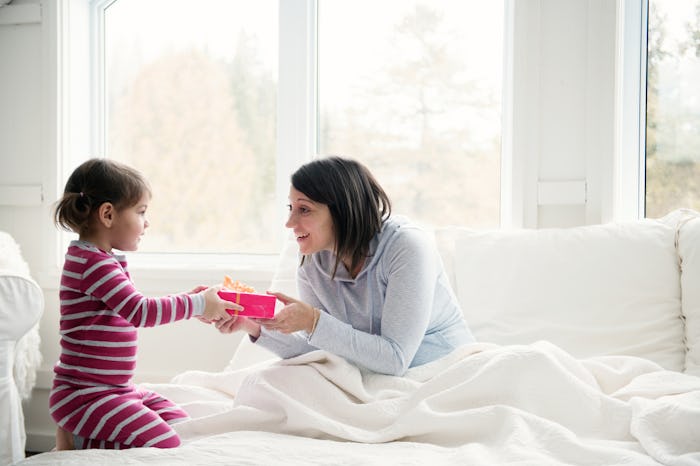 little girl giving mom a mother's day gift