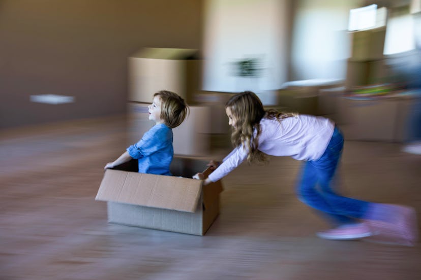 Playing with a cardboard box is a summer activity kids can do at home. 