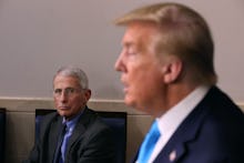 Donald Trump giving a speech with Anthony Fauci sitting in the same room