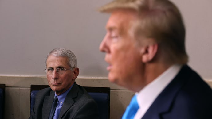 Donald Trump giving a speech with Anthony Fauci sitting in the same room
