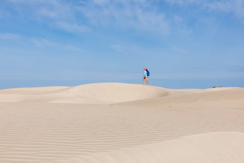 A woman hikes across a dry desert. Why is my vagina so dry? We asked an MD to explain 9 possible cul...