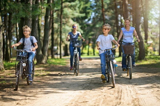 a family riding bikes on a dirt road