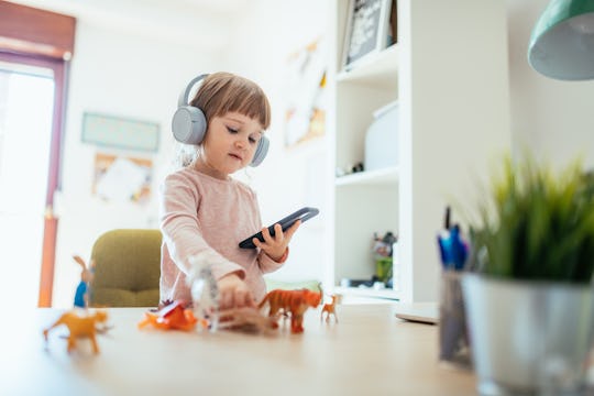 a little girl playing an iphone app