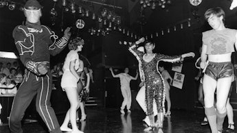 A group of people dancing in a photo taken in Studio 54