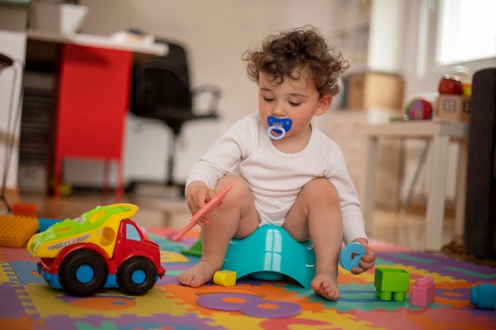 toddler sitting on a potty