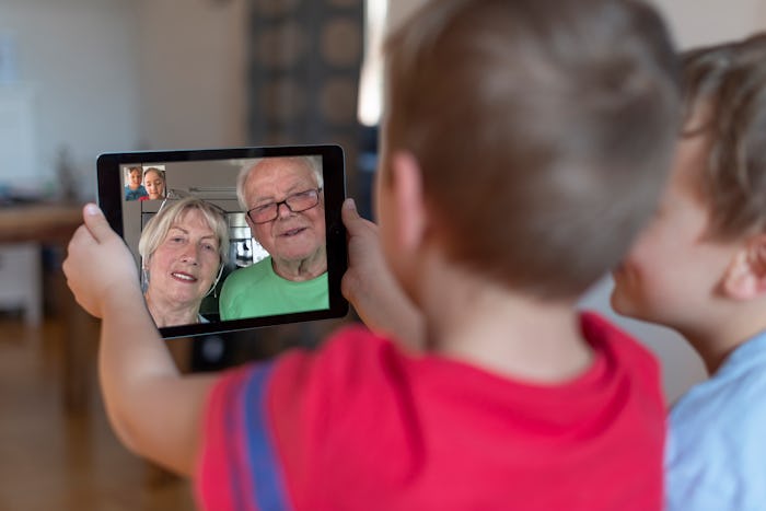 two little boys video chatting with grandparents