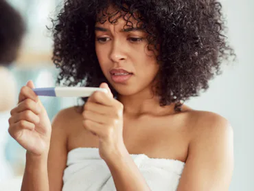 woman looking at ovulation test