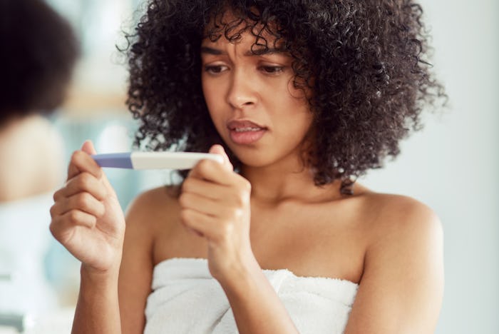 woman looking at ovulation test