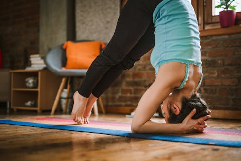 A person in dolphin pose. Exercise-induced anxiety can make working out very scary, but there are wa...