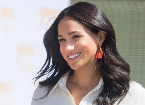 Meghan Markle's best hairstyles include bouncy waves, a tidy topknot, ponytails, and her signature l...