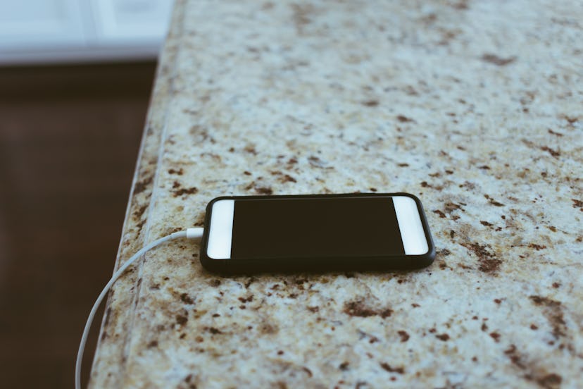 a phone charging on a kitchen counter