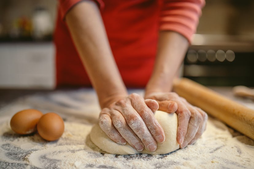 A woman bakes bread at home. If you're feeling calm during the coronavirus pandemic, experts say tha...