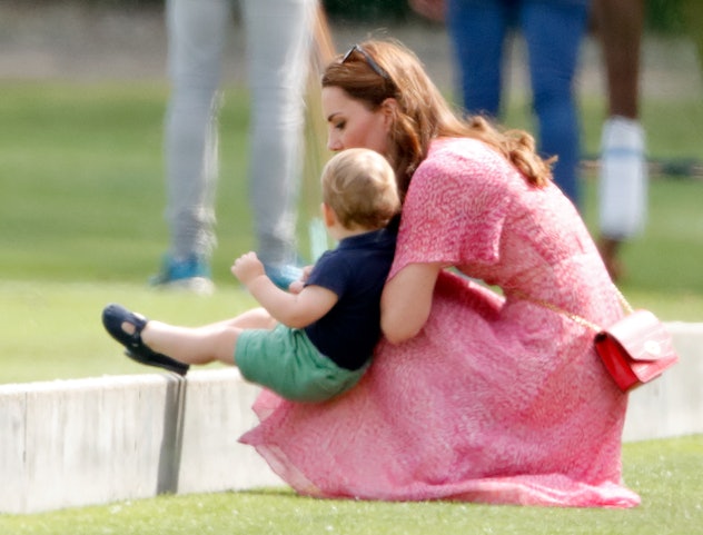Prince Louis uses his mom as a chair.