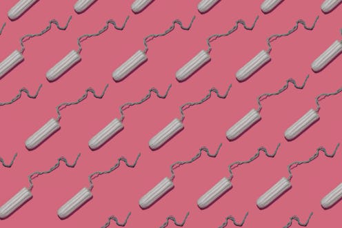 Plain tampons on a pink background. We asked an OB-GYN to debunk these toxic shock syndrome myths.